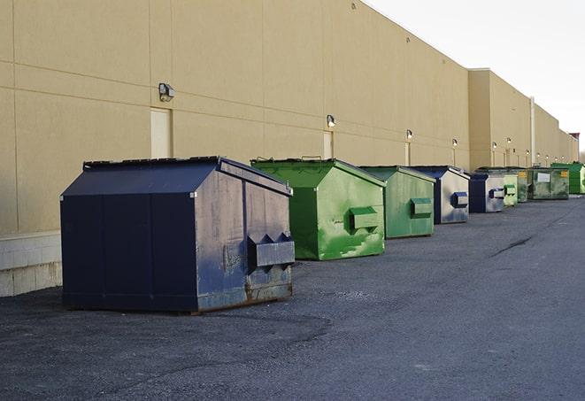 construction dumpsters on a worksite surrounded by caution tape in Aroma Park